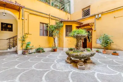a courtyard with a planter in front of a building at 