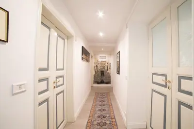 a hallway with two doors and a rug at Roman Holidays cuore dell'Impero in Rome