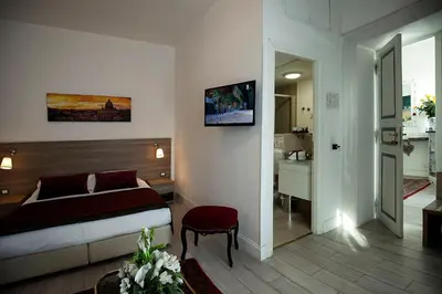 a hotel room with a bed and a bathroom at Roman Holidays cuore dell'Impero in Rome