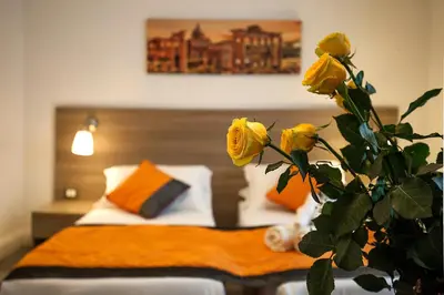 a bedroom with a bed with yellow roses at Roman Holidays cuore dell'Impero in Rome