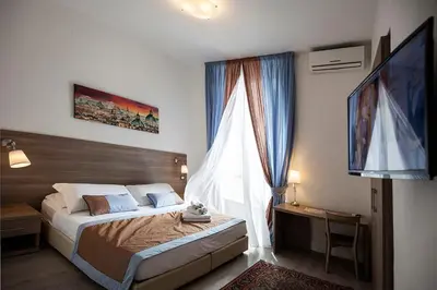 a bedroom with a bed and a large window at Roman Holidays cuore dell'Impero in Rome