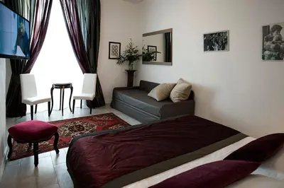 a living room with a bed and a couch at Roman Holidays cuore dell'Impero in Rome