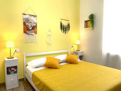 a bedroom with a bed with yellow walls at My Dream in Rome in Rome