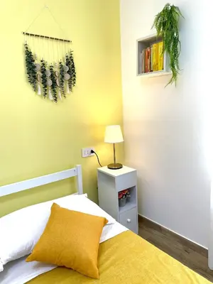 a bedroom with a bed and a plant on the wall at My Dream in Rome in Rome