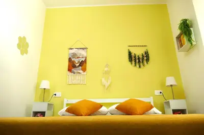 a bedroom with a bed with orange pillows on it at My Dream in Rome in Rome