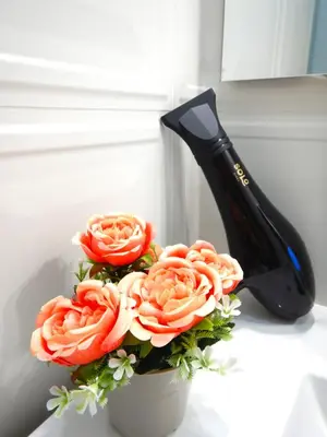 a black knife sitting next to a bouquet of flowers at My Dream in Rome in Rome