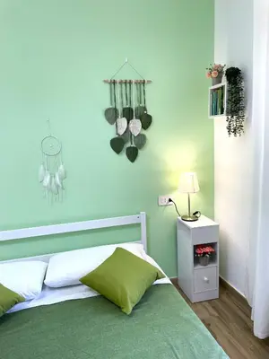 a bedroom with a bed and a blue wall at My Dream in Rome in Rome
