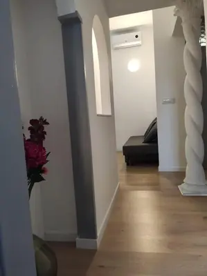 a hallway with a black couch in a white room at Tranquillità a Roma! in Rome