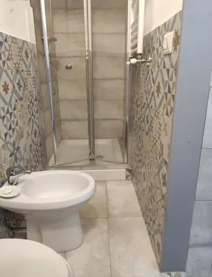 a bathroom with a shower and a toilet and a sink at Tranquillità a Roma! in Rome