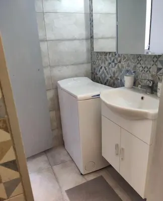 a small bathroom with a sink and a washing machine at Tranquillità a Roma! in Rome