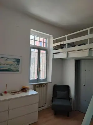 a room with a chair and a desk and a window at Tranquillità a Roma! in Rome