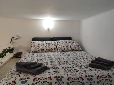 a bedroom with a large bed with pillows on it at Tranquillità a Roma! in Rome