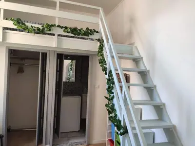 a white staircase with plants on it in a room at Tranquillità a Roma! in Rome
