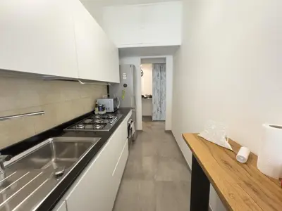 a kitchen with a sink and a stove top oven at Toto Vatican House in Rome