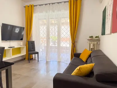 a living room with a couch and a tv at Toto Vatican House in Rome