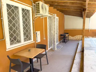 a room with a table and chairs and a window at Toto Vatican House in Rome
