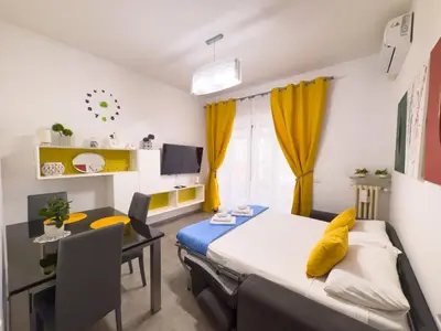 a bedroom with a bed and a table and a desk at Toto Vatican House in Rome