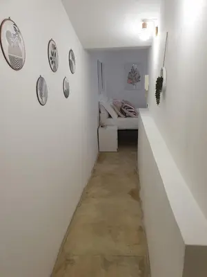 a white hallway with a bed in a room at San Cosimato cozy flat in Rome
