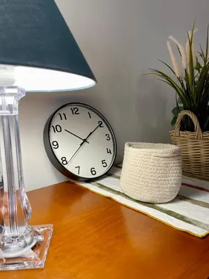 a clock sitting on a table next to a lamp at Anna's House in Rome