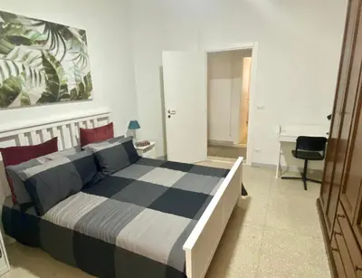 a bedroom with a bed and a desk at Anna's House in Rome