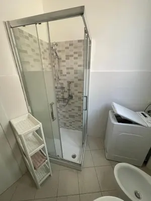 a bathroom with a shower and a toilet and a sink at Anna's House in Rome