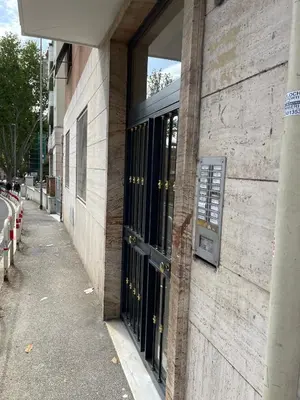 a building with black doors on the side of a street at Anna's House in Rome