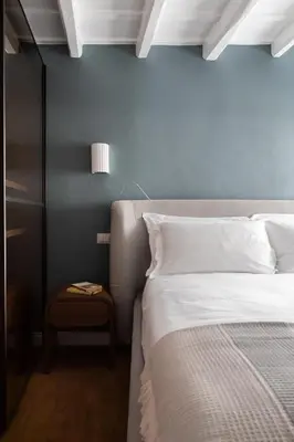 a bedroom with a bed and a night stand next to it at Elegance and Charm in Splendid Via Giulia in Rome