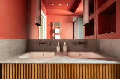 a bathroom with two sinks in front of a mirror at Elegance and Charm in Splendid Via Giulia in Rome