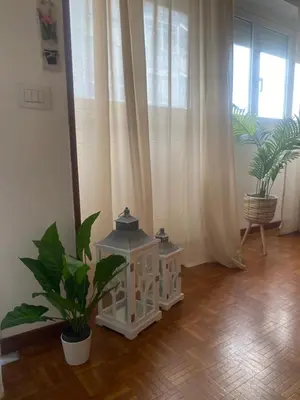 a room with two potted plants and a window at Alloggio Turistico Agiati in Rome