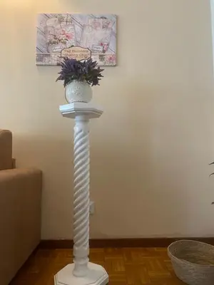 a white pole with a vase on top of it at Alloggio Turistico Agiati in Rome