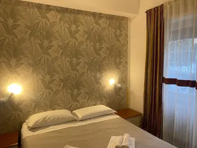 a bedroom with a bed with a floral wallpaper at Casa di Flavio a San Pietro in Rome