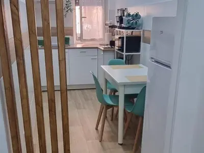 a kitchen with a table and chairs and a table and a kitchen at Domus green in Rome