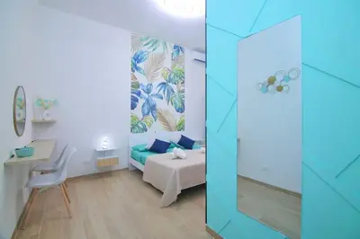 a room with a bedroom with a bed and a table at Domus green in Rome