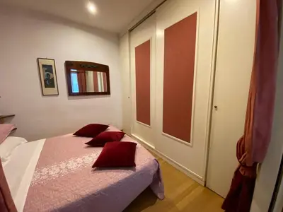 a bedroom with a bed with red pillows on it at Leonina Luxury Euroform in Rome