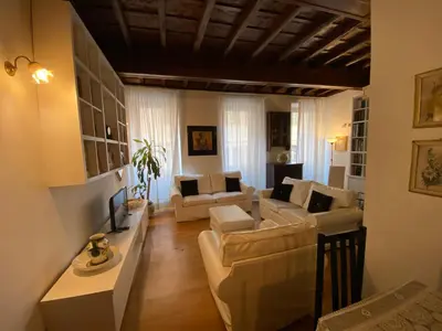 a living room with white furniture and a wooden ceiling at Leonina Luxury Euroform in Rome