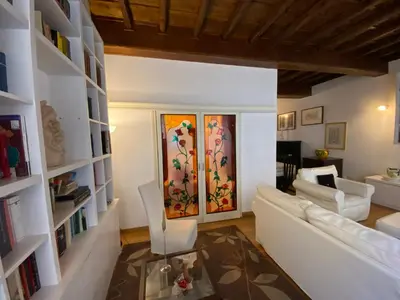 a living room with a white couch and a table at Leonina Luxury Euroform in Rome