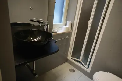 a bathroom with a sink and a toilet at B&S Suite Colosseo in Rome