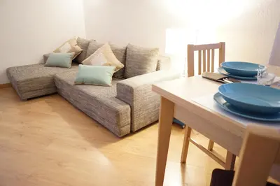 a living room with a couch and a table with plates on it at B&S Suite Colosseo in Rome