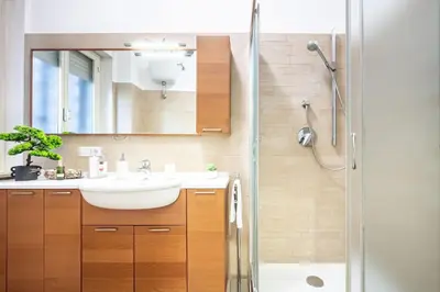 a bathroom with a sink and a shower at King Size Apartment WiFi AIR CONDITIONING TV50 10MIN COLOSSEO-TRASTEVERE in Rome
