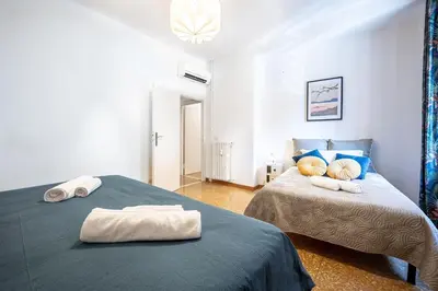 a bedroom with two beds with towels on them at King Size Apartment WiFi AIR CONDITIONING TV50 10MIN COLOSSEO-TRASTEVERE in Rome