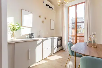 a kitchen with a dining table and a table and chairs at Daplace - Romina Apartment in Rome