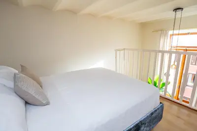 a bedroom with a white bed and a window at Daplace - Romina Apartment in Rome