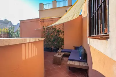 a balcony with a blue bench and a table at Daplace - Romina Apartment in Rome