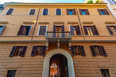a building with a balcony on the front of it at Daplace - Romina Apartment in Rome