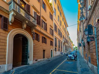 an alley with a motorcycle parked next to a building at Daplace - Romina Apartment in Rome