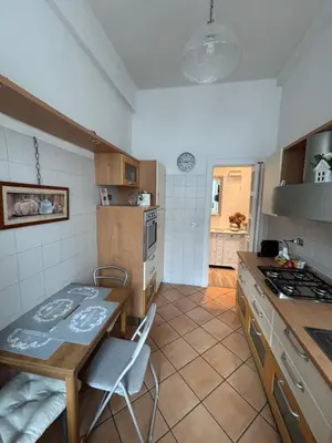 a kitchen with a table and a stove top oven at Sweet Anna in Rome