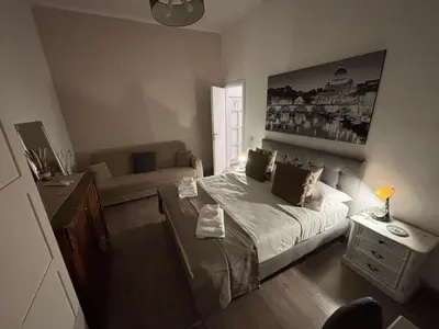 a small bedroom with a bed and a couch at Sweet Anna in Rome