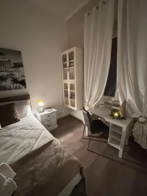 a bedroom with a bed and a desk and a table at Sweet Anna in Rome