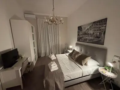 a bedroom with a white bed and a television at Sweet Anna in Rome