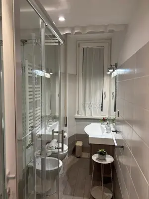 a bathroom with a toilet and a sink and a shower at Sweet Anna in Rome